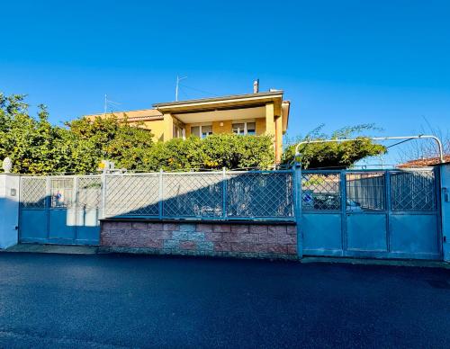 a blue gate in front of a house at Fil Rouge in Ciampino
