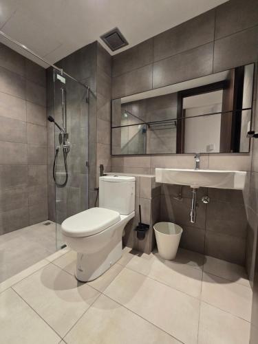 a bathroom with a toilet and a sink and a shower at K Avenue Kota Kinabalu by Merveille - Sabah in Donggongon