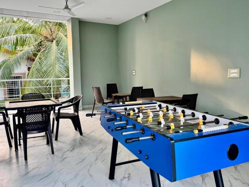 a large blue chess board in a room with tables and chairs at Golden Pearl Resort By Gemstone Hospitality in Alibag
