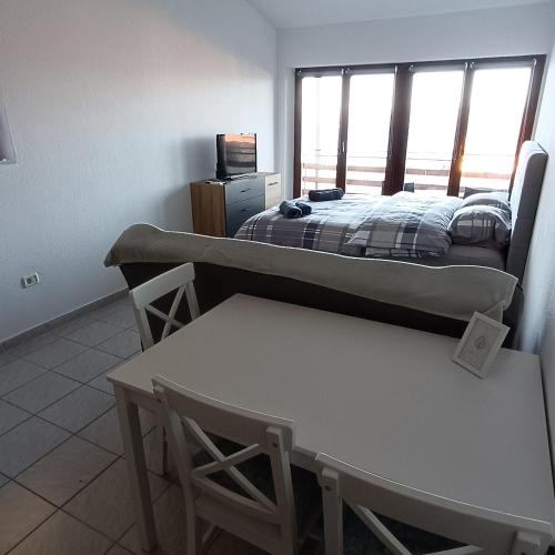 a bedroom with a bed and a table and a tv at Studio Vesna & Žan in Koper