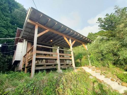 a building with a solar roof on a hill at 南伊豆ランドホピア Minami Izu Land Hopia in Minamiizu