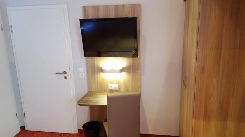 a room with a flat screen tv on a wall at Hotel Trutzpfaff in Speyer