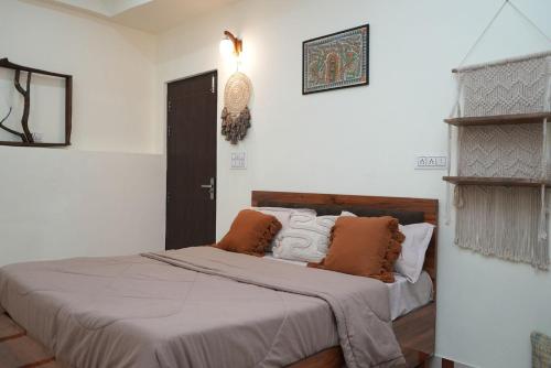 a bedroom with a bed with pillows on it at Mild Life Hostel Rishikesh in Rishīkesh