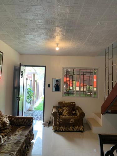 a living room with a couch and a chair at Reymen's Transient in San Fernando