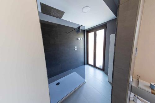 a bathroom with a white tub and a large window at River Hotel in Castel di Sangro