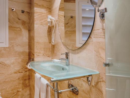 a bathroom with a sink and a mirror at Grupotel Playa Camp de Mar - Adults Only in Camp de Mar