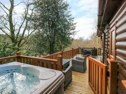 a hot tub on the deck of a house at Esk Pike in Windermere