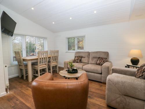 a living room with a couch and a table at Esk Pike in Windermere