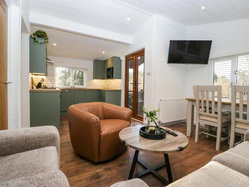 a living room with a couch and a table at Esk Pike in Windermere