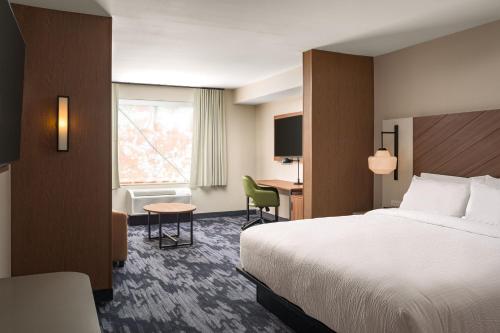 a hotel room with a bed and a desk at Fairfield by Marriott Inn & Suites Cullman in Cullman