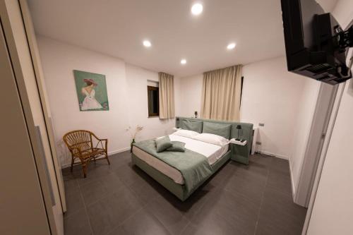 a bedroom with a bed and a chair in it at River Hotel in Castel di Sangro