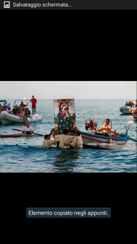 a group of people in boats in the water at Appartamento Nonna Lina in Custonaci