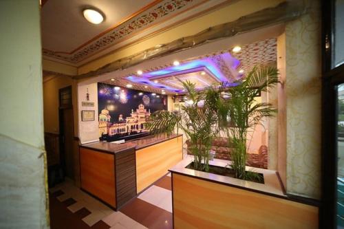 un bar dans un restaurant avec des plantes en pot dans l'établissement Hotel Golden Heritage Deluxe, à Jaipur