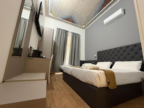 a bedroom with a large bed with a ceiling at Conte GuestHouse in Rome
