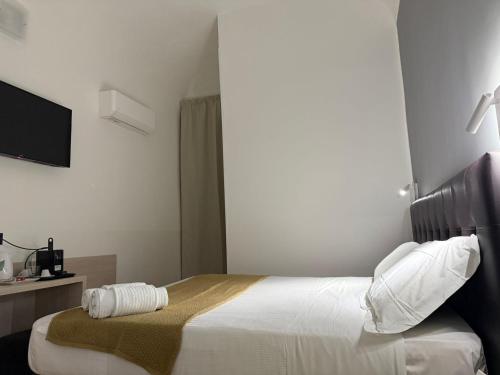 a hotel room with a bed and a television at Conte GuestHouse in Rome