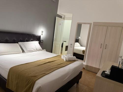 a bedroom with a large bed and a mirror at Conte GuestHouse in Rome