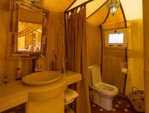 a bathroom with a sink and a toilet at Sunshine luxury tent in Merzouga