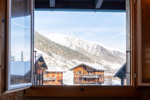 a window with a view of a mountain at Chalet Daheim - Ferienwohnung OG in Reckingen - Gluringen