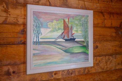 a picture of a painting of a sailboat on a wall at Chalet Daheim - Ferienwohnung OG in Reckingen - Gluringen