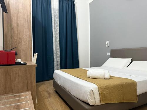 a bedroom with a bed with blue curtains at Conte GuestHouse in Rome