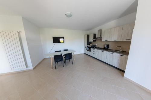 a kitchen with a table and chairs in a room at River Hotel in Castel di Sangro