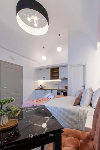 a bedroom with a bed and a table in a room at Santorini Villatzio Suites in Mesaria