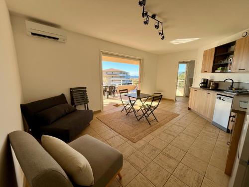 un salon avec un canapé et une table dans l'établissement Très beau T3 5 min plage à pieds, à Albitreccia