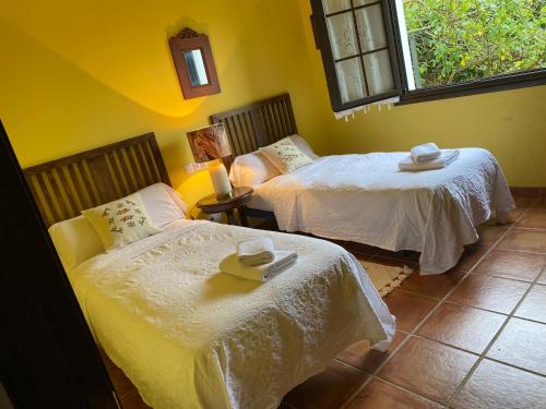 a room with two beds with hats on them at Villa del Mar in Villaviciosa