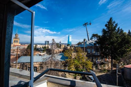 a view of a city from a balcony at City Inn - Boutique Hotel Tbilisi in Tbilisi City