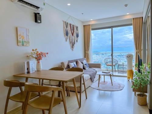 a living room with a table and a couch at The Song Luxury Vung Tau - Khang Apartment 1 in Vung Tau