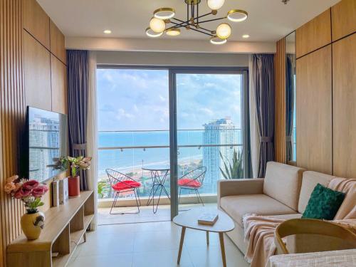 a living room with a couch and a view of the ocean at The Song Luxury Vung Tau - Khang Apartment 1 in Vung Tau