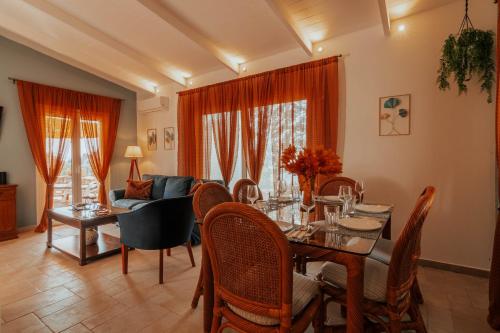 a living room with a table and a couch at Kastraki Sea View in Tolo