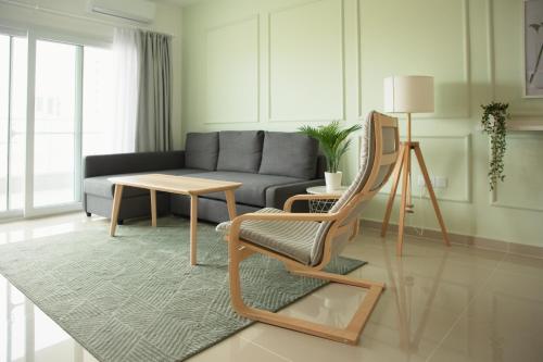 a living room with a couch and a chair and a table at Spacious One Bedroom Apartment in Caesar Resort & SPA, Long Beach in Perivolia tou Trikomou