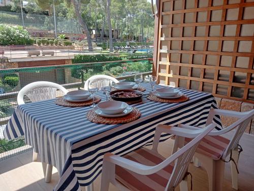 a table with a blue and white striped table cloth at Apartamento EDEN MAR I by HR COSTABRAVA in Calonge