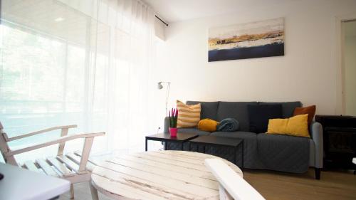 a living room with a couch and a table at Apartamento EDEN MAR I by HR COSTABRAVA in Calonge