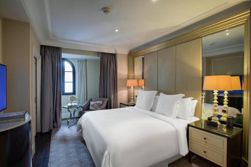 a large white bed in a hotel room at Four Seasons Hotel Baku in Baku