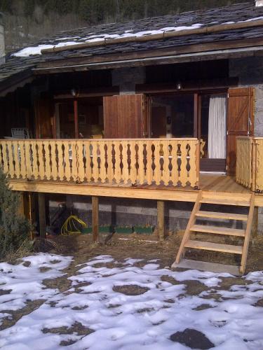 a wooden deck on a house in the snow at L'arpont in Champagny-en-Vanoise