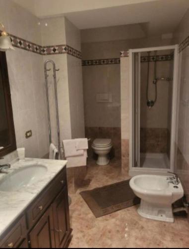 a bathroom with a toilet and a sink and a shower at Maison Manni' B&B in Soverato Marina