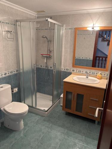 a bathroom with a shower and a toilet and a sink at Casa Frijol 20metres from the beach in Los Alcázares