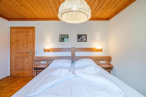 a large bed in a bedroom with a ceiling at Appartements Spitzegel in Hermagor