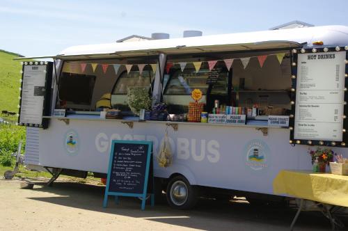 a food truck with a sign in front of it at Badgers Den, a beautiful log cabin in a secluded valley close to the beach in Bantham