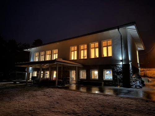 a building with lit windows at night at Villa The Old School Plana with Hot Pool & SPA by BookVillaBG in Plana
