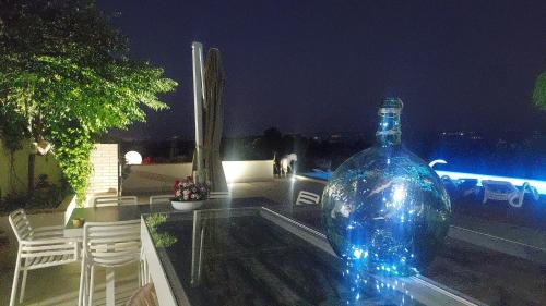 a large blue bottle sitting on top of a glass table at Casa del olivo Lucio en Alomartes in Alomartes