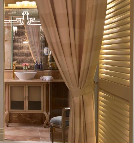 a bathroom with a sink and a mirror at Nuvole Garden Hotel in Brunate
