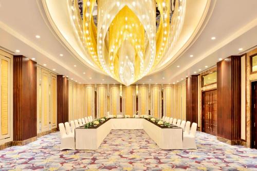 a conference room with a long table and chairs at Sheraton Grand Pune Bund Garden Hotel in Pune