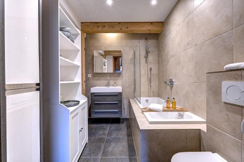 une salle de bain avec un lavabo et des toilettes dans l'établissement Tiki Lodge - hot tub & sauna, à Chamonix-Mont-Blanc