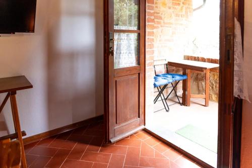 an open door to a room with a table and a chair at Borgo Il Poggio Agriturismo in Montaione