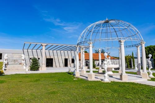 a gazebo in front of a building at Villam Vale da Estrela in Guimarães