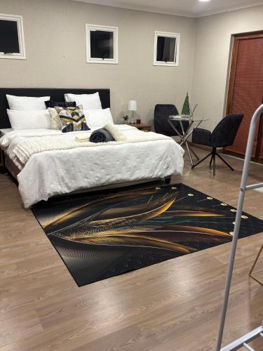a bedroom with a bed and a rug on the floor at Joy's Place - Fourways BnB in Sandton