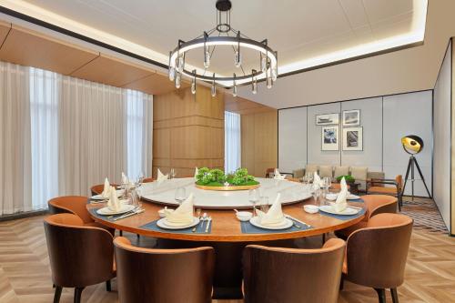 a dining room with a table and chairs at Four Points by Sheraton Dali, Erhai in Dali